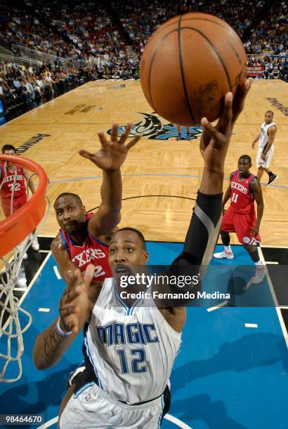 Dwight Howard of the Orlando Magic shoots against Elton Brand of the Philadelphia 76ers during the game on April 14, 2010 at Amway Arena in Orlando,...