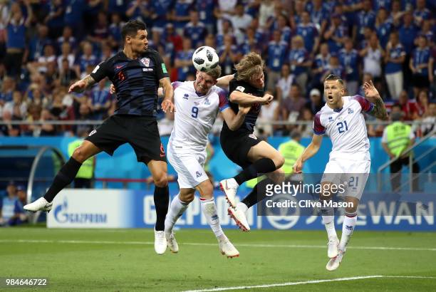 Bjorn Sigurdarson of Iceland wins a header from Dejan Lovren of Croatia and Tin Jedvaj of Croatia during the 2018 FIFA World Cup Russia group D match...