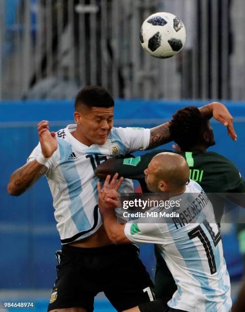 Onyinye Ndidi of Nigeria national team vies for a header with Marcos Rojo and Javier Mascherano of Argentina national team during the 2018 FIFA World...