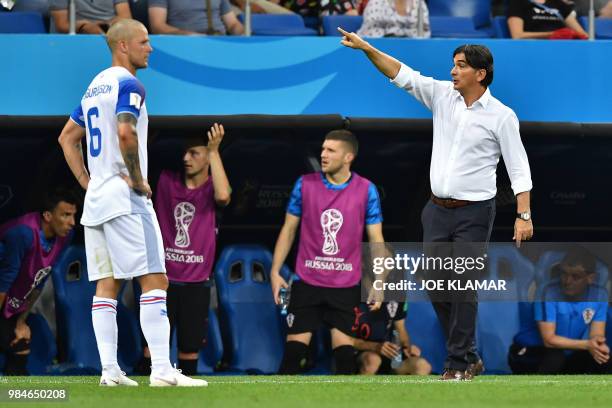 Croatia's coach Zlatko Dalic gestures next to Iceland's defender Ragnar Sigurdsson during the Russia 2018 World Cup Group D football match between...