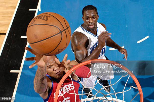 Marreese Speights of the Philadelphia 76ers shoots against Brandon Bass of the Orlando Magic during the game on April 14, 2010 at Amway Arena in...
