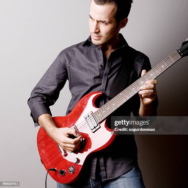 young man playing guitar - soloist stock pictures, royalty-free photos & images