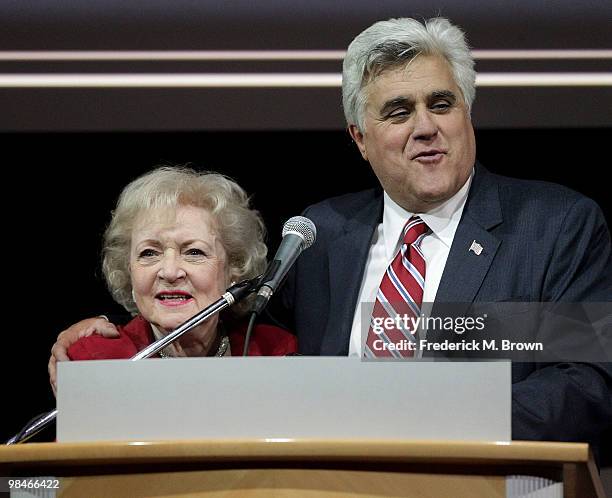 Actress Betty White and television host Jay Leno speak during the American Women in Radio and Television 2010 Genii Awards at the Skirball Cultural...