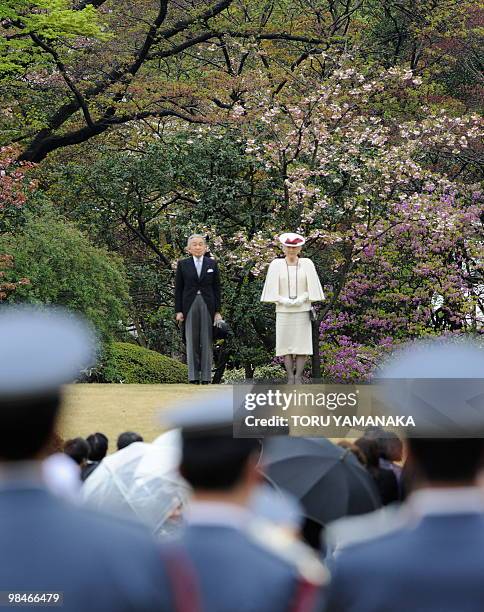 Japanese Emperor Akihito and Empress Michiko listen to the national anthem upon their arrival at Akasaka Imperial Garden for the spring garden party...