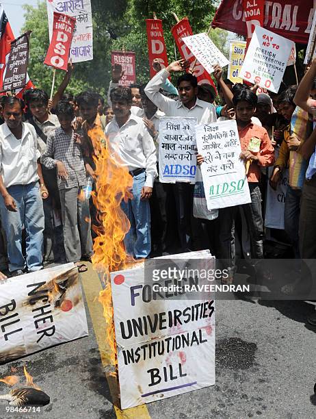 Students from All India Democratic Students Organisation shout anti-government slogan as they burn a mockup of the Foreign Education Provider Bill...