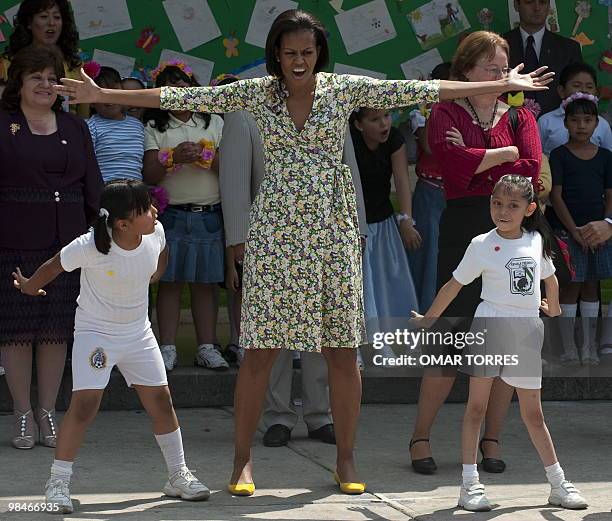 First Lady Michelle Obama sings and dances with children during her visit to the "7 de Enero" primary public school in Mexico City on April 14, 2010....
