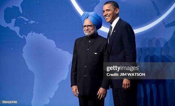 President Barack Obama greets the Prime Minister of India Manmohan Singh upon his arrival for dinner during the Nuclear Security Summit at the...