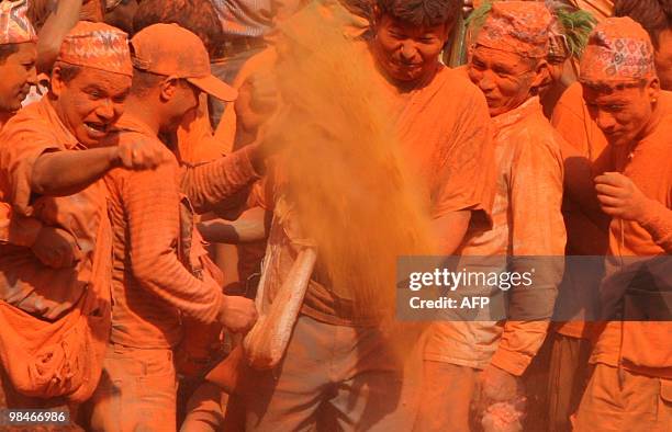 Nepalese people smear vermillion powder during the Bisket Jatra festival in Thimi, in the outskirts of Kathmandu, on April 15, 2010. The traditional...