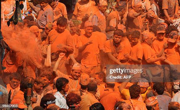 Nepalese people smear vermillion powder during the Bisket Jatra festival in Thimi, in the outskirts of Kathmandu, on April 15, 2010. The traditional...