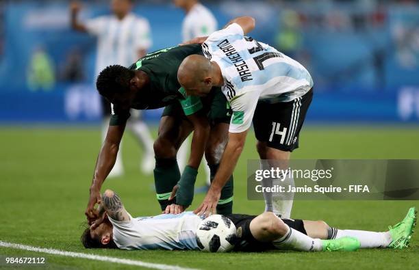 Lionel Messi of Argentina is helped by John Obi Mikel of Nigeria and Javier Mascherano during the 2018 FIFA World Cup Russia group D match between...