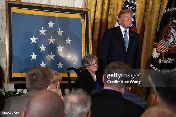 President Donald Trump and Pauline Lyda Wells Conner , widow of U.S. Army First Lieutenant Garlin M. Conner, listen to citation during an East Room...