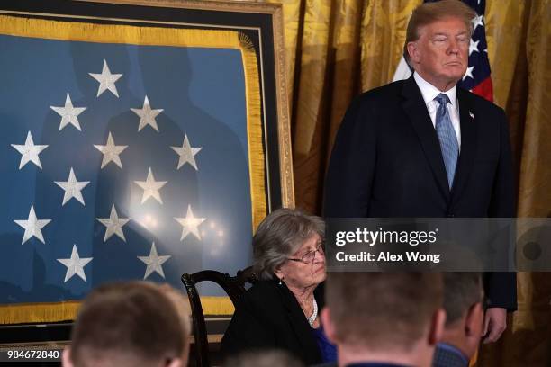 President Donald Trump and Pauline Lyda Wells Conner , widow of U.S. Army First Lieutenant Garlin M. Conner, listen to citation during an East Room...