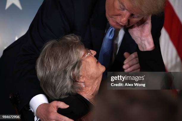 President Donald Trump and Pauline Lyda Wells Conner , widow of U.S. Army First Lieutenant Garlin M. Conner, share a moment during an East Room Medal...