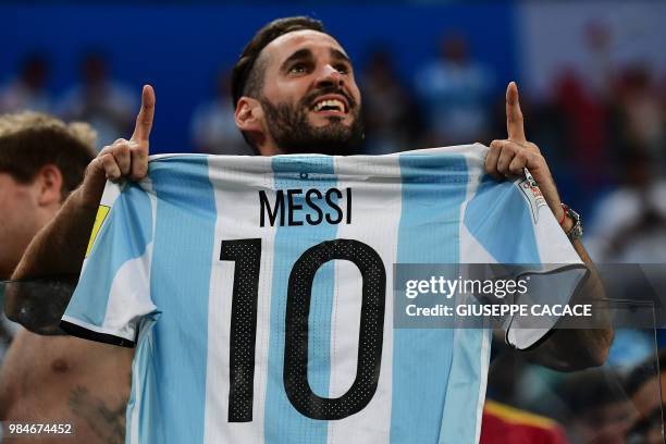 Argentina supporters carry a jersey of Argentina's forward Lionel Messi during the Russia 2018 World Cup Group D football match between Nigeria and...