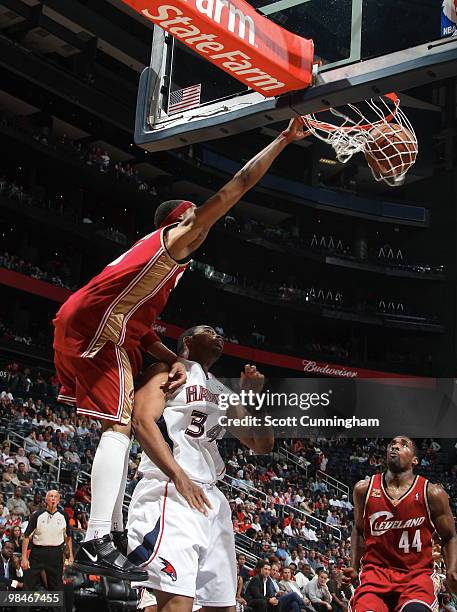 Jamario Moon of the Cleveland Cavaliers dunks over Jason Collins of the Atlanta Hawks on April 14, 2010 at Philips Arena in Atlanta, Georgia. NOTE TO...