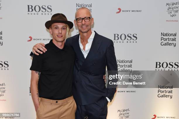 Jamie Campbell Bower and Ingo Wilts, Chief Brand Officer for HUGO BOSS, attend a private view of the "Michael Jackson: On The Wall" exhibition...