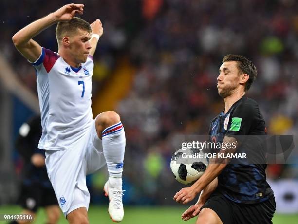 Iceland's midfielder Johann Gudmundsson vies with Croatia's defender Josip Pivaric during the Russia 2018 World Cup Group D football match between...