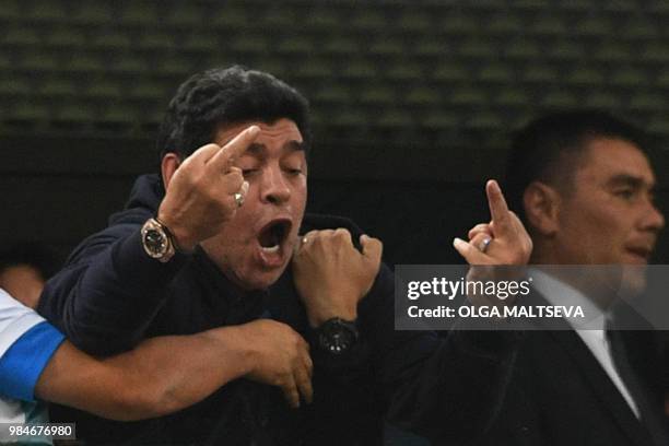 Retired Argentina player Diego Maradona gestures during the Russia 2018 World Cup Group D football match between Nigeria and Argentina at the Saint...