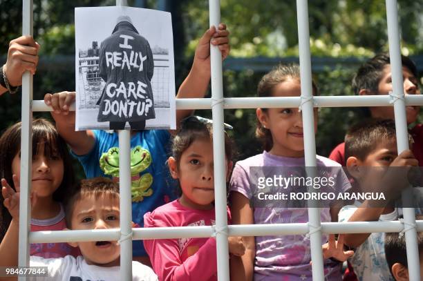 Children take part in a protest against US immigration policies outside the US embassy in Mexico City on June 26, 2018. - Three undocumented migrant...