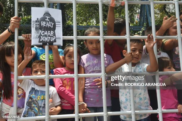 Children take part in a protest against US immigration policies outside the US embassy in Mexico City on June 26, 2018. - Three undocumented migrant...