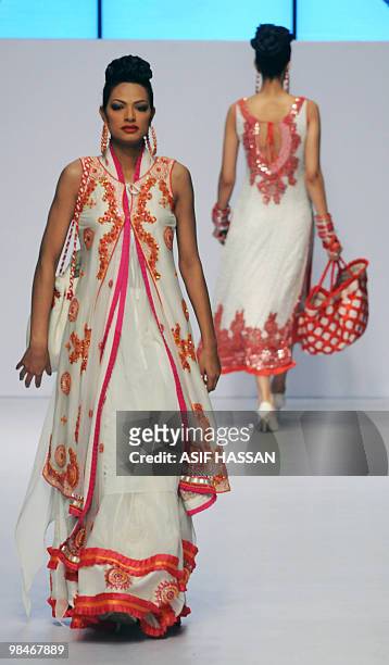 Pakistani models present creation by Ahmed Bilal on the last day of the Karachi Fashion Week on April 9, 2010. The event is scheduled to feature 52...