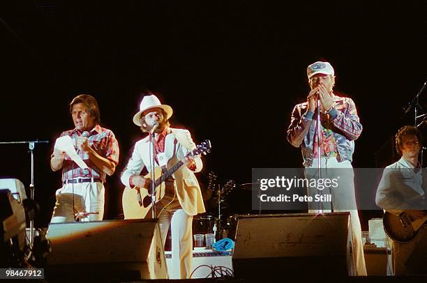 Bruce Johnston, Al Jardine and Mike Love of The Beach Boys with session guitarist Ed Carter, perform on stage at Knebworth on June 21st, 1980 in...
