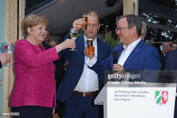 Angela Merkel, Joachim Stamp and Armin Laschet attend the Landesvertretung NRW summer party on June 26, 2018 in Berlin, Germany.