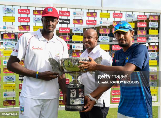 Jason Holder of West Indies and Suranga Lakmal of Sri Lanka receives the trophy from David Hinds of Sandals at the end of day 4 of the 3rd Test...