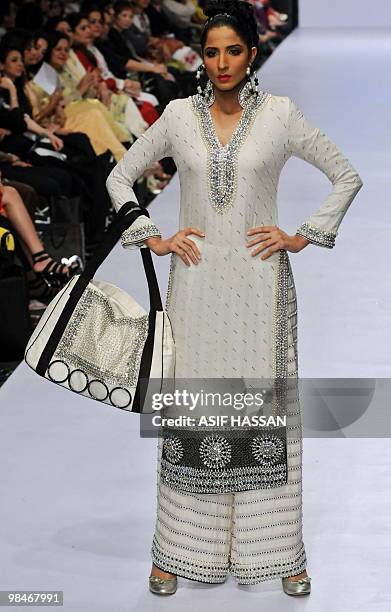 Pakistani model presents a creation by Ahmed Bilal on the last day of the Karachi Fashion Week on April 9, 2010. The event is scheduled to feature 52...