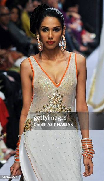 Pakistani model presents a creation by Ahmed Bilal on the last day of the Karachi Fashion Week on April 9, 2010. The event is scheduled to feature 52...