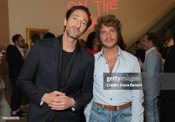 Adrien Brody and Luke Day attend a private view of the "Michael Jackson: On The Wall" exhibition sponsored by HUGO BOSS at the National Portrait...