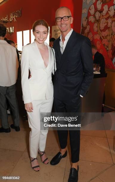 Eleanor Tomlinson and Ingo Wilts, Chief Brand Officer for HUGO BOSS, attend a private view of the "Michael Jackson: On The Wall" exhibition sponsored...