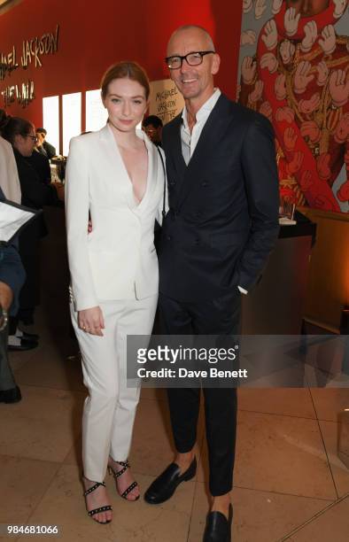 Eleanor Tomlinson and Ingo Wilts, Chief Brand Officer for HUGO BOSS, attend a private view of the "Michael Jackson: On The Wall" exhibition sponsored...