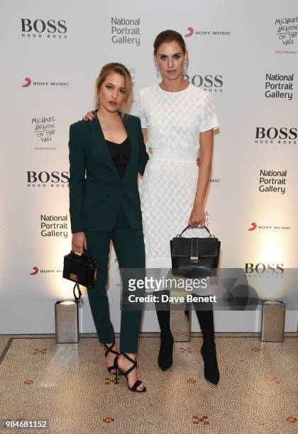 Tess Ward and Sabrina Percy attend a private view of the "Michael Jackson: On The Wall" exhibition sponsored by HUGO BOSS at the National Portrait...
