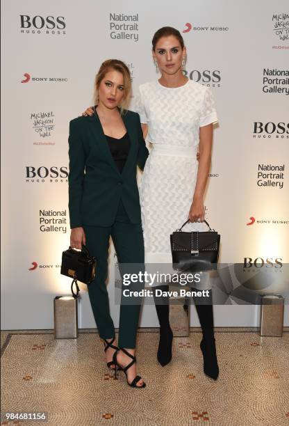 Tess Ward and Sabrina Percy attend a private view of the "Michael Jackson: On The Wall" exhibition sponsored by HUGO BOSS at the National Portrait...