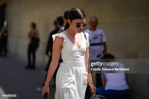 Guest wears a white dress, outside Balmain, during Paris Fashion Week - Menswear Spring-Summer 2019, on June 24, 2018 in Paris, France.