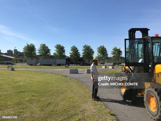 Construction crews are idle near a pedestrian roundabout at an outdoor venue in Ottawa, Canada, June 26, 2018 less than two weeks before the start of...