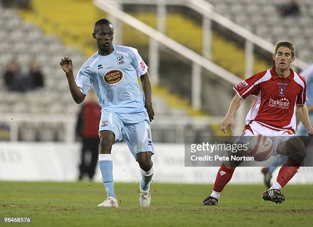 Abdul Osman of Northampton Town plays the ball watched by Danny Harrison of Rotherham United during the Coca Cola League Two Match between Rotherham...