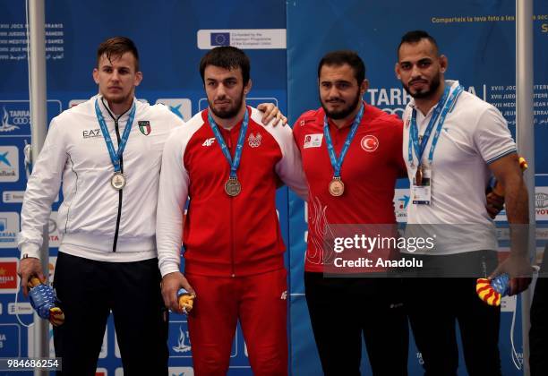 Bronze medalist Yunus Dede of Turkey poses for a photo after winning against Antonio Ruiz Rodriguez of Spain in 97kg Men's Freestyle Wrestling within...