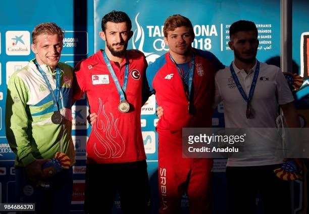 Gold medalist Selahattin Kilicsallayan of Turkey poses for a photo after winning against David Habat of Slovenia in 65kg Men's Freestyle Wrestling...