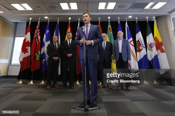 Bill Morneau, Canada's minister of finance, center, speaks during a press conference following a meeting with provincial and territorial finance...