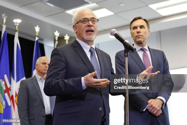 Carlos Leito, Quebec's finance minister, left, speaks as Bill Morneau, Canada's minister of finance, listens during a press conference following a...