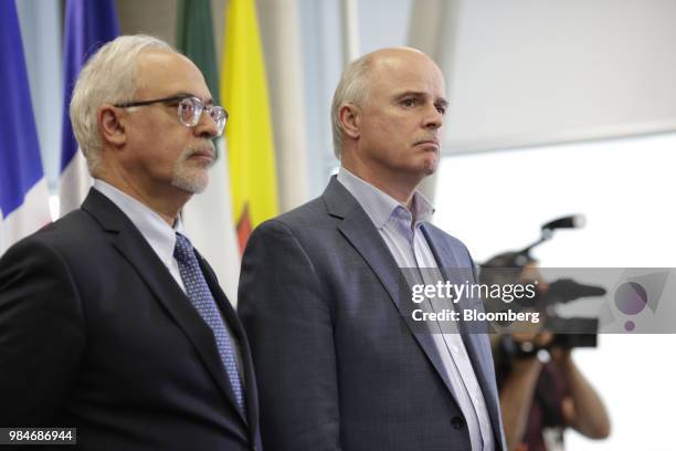 Tom Osborne, Newfoundland and Labrador's finance minister, right, and Carlos Leito, Quebec's finance minister, listen during a press conference...