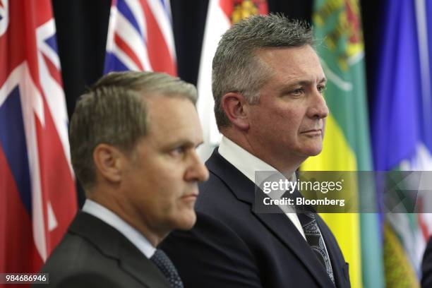 Heath MacDonald, Prince Edward Island's finance minister, right, and Cameron Friesen, Manitoba's finance minister, listen during a press conference...