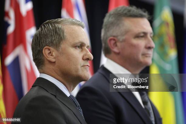 Cameron Friesen, Manitoba's finance minister, left, and Heath MacDonald, Prince Edward Island's finance minister, listen during a press conference...