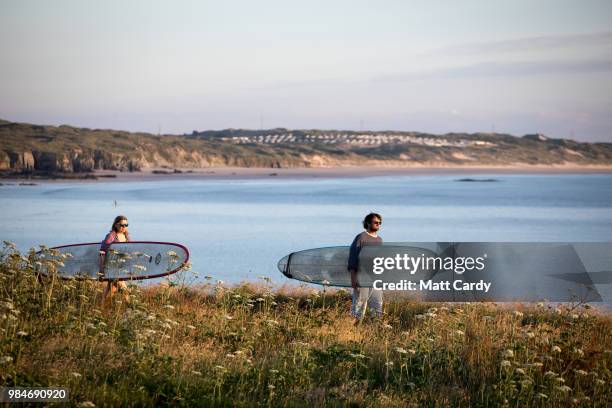 People enjoy the fine weather near Godrevy Lighthouse near Gwithian on June 26, 2018 in Cornwall, England. Parts of the UK are currently basking in...