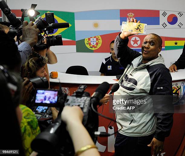 Man shows to the media the official 2010 FIFA World Cup ticket he just purchased on April 15, 2010 at the Maponya shopping mall in Soweto on the...