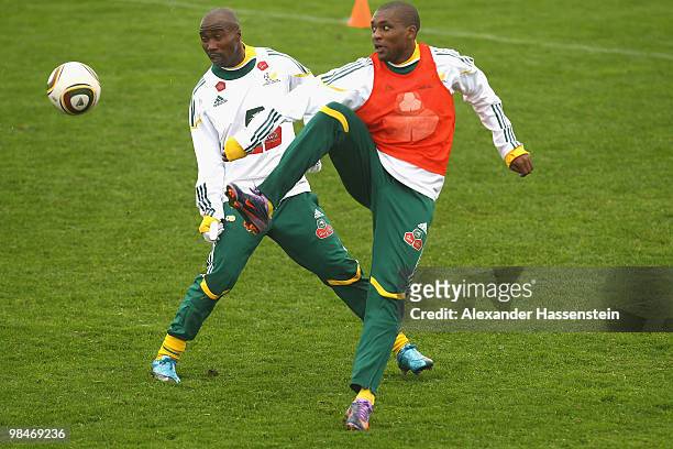 Siyabonga Nomvete of the South African national football team fights for the ball with his team mate Katlego Mphela during a training session of the...