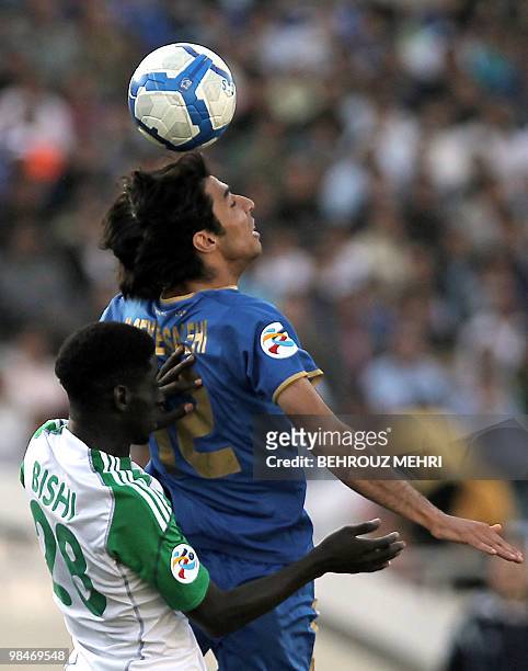 Al-Ahli's Jufain Ali al-Bishi challenges Esteghlal's Mehdi Seyed Salehi as he heads the ball during their AFC Champions League group A football match...