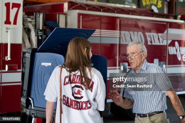 Poll manager Jim LoCicero, right, helps voter Callie Farrell during a primary runoff election on June 26, 2018 in Irmo, South Carolina. The most...